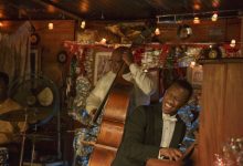 Dr. Donald Shirley (Mahershala Ali, right) gives an impromptu performance in Green Book, directed by Peter Farrelly.